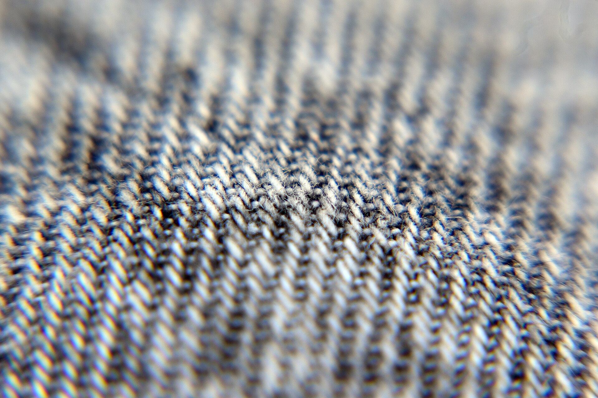 A close-up shows the textured weave of gray denim fabric.