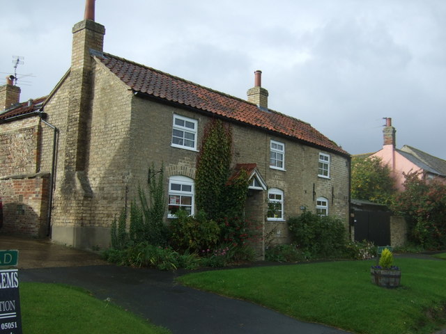 Stone House | Rapidly Viral A quaint stone house with a red tile roof sits beside a curved pathway, illustrating the concept of online reach.
